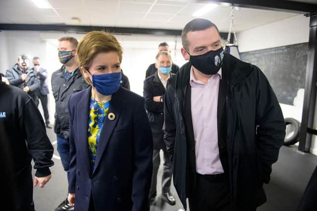 Nicola Sturgeon and Scottish Conservative leader Douglas Ross visit the Bluevale Community Club in Haghill, Glasgow, together (Picture: Wattie Cheung/pool/Getty Images)