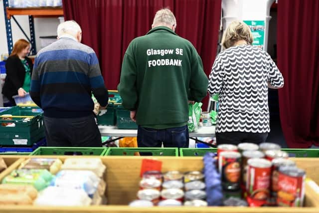 Volunteers and staff sort through food donations at Glasgow South East Food Bank, part of the Trussell Trust food bank network (Picture: Jeff J Mitchell/Getty Images)