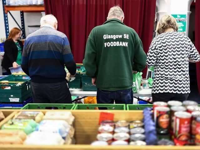 Volunteers and staff sort through food donations at Glasgow South East Food Bank (Picture: Jeff J Mitchell/Getty Images)