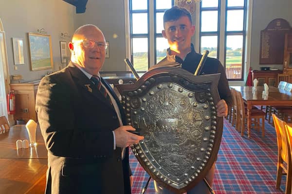 Kirkhill's Lewis Irvine pictured after being presented with the Edward Trophy by Glasgow Golf Club captan Peter McEachran following his win at Gailes Links in Ayshire.