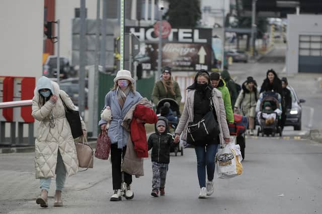 Refugees fleeing conflict in Ukraine arrive at the Medyka border crossing, in Poland. The UN refugee agency, UNHCR, has warmed Russia's invasion will have "devastating humanitarian consequences" on civilians. (AP Photo/Visar Kryeziu)