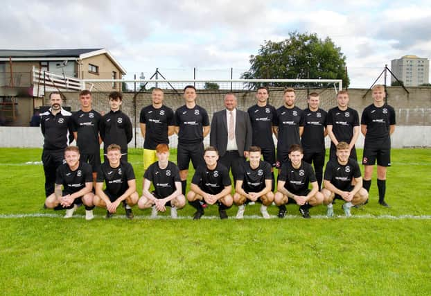 Phil Anderson, Managing Director of Phil Anderson Financial Services, with the Sunnybank FC squad.