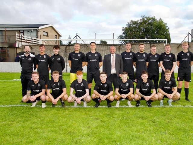 Phil Anderson, Managing Director of Phil Anderson Financial Services, with the Sunnybank FC squad.