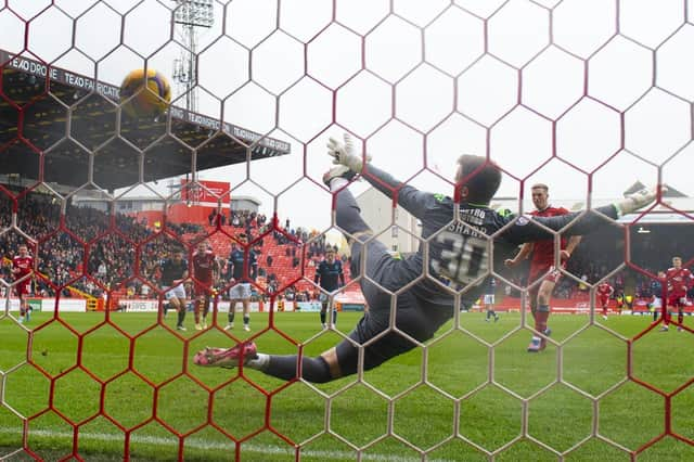 Lewis Ferguson hammers home Aberdeen's winning penalty against Dundee.