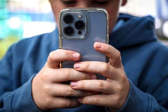 Sometimes it can seem young people are never off their phones (Picture David GRAY / AFP via Getty Images)