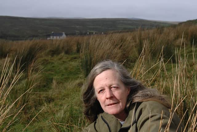 Author Sara Maitland near her isolated cottage in Galloway in the background. PIC: TSPL.