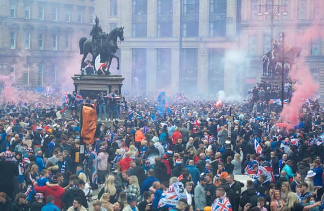 Rangers fans celebrate winning the title at George Square in Glasgow.