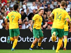 Jason Cummings celebrates with his Australia teammates after scoring in the 2-0 win over New Zealand in Auckland. (Photo by Hannah Peters/Getty Images)