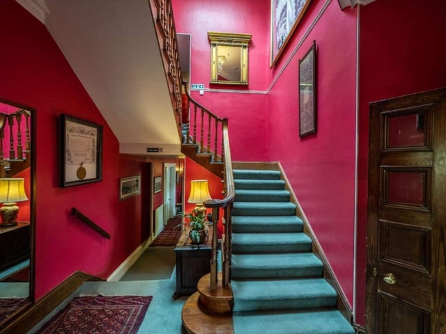 Stairs leading up to the first floor of the house - featuring eleven generously sized bedrooms, two dressing rooms and six bathrooms.