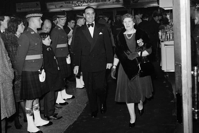 Hearts footballer Tommy Walker and his wife walk past a guard of honour at the premiere of film 'The Longest Day' at the New Victoria Cinema in February 1963.