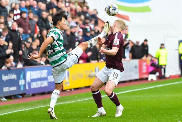 Celtic's Yang Hyun-jun fouls Hearts' Alex Cochrane with a high foot which led to a red card following a VAR check. (Photo by Paul Byars / SNS Group)