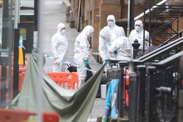Forensic officers at the scene in West George Street, Glasgow, where Badreddin Abadlla Adam, 28, from Sudan, was shot dead by officers after six people - including 42-year-old police constable David Whyte - were injured.