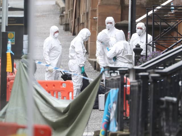 Forensic officers at the scene in West George Street, Glasgow, where Badreddin Abadlla Adam, 28, from Sudan, was shot dead by officers after six people - including 42-year-old police constable David Whyte - were injured.