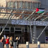 Four protesters have climbed onto the Scottish Parliament roof. Picture: Lisa Ferguson