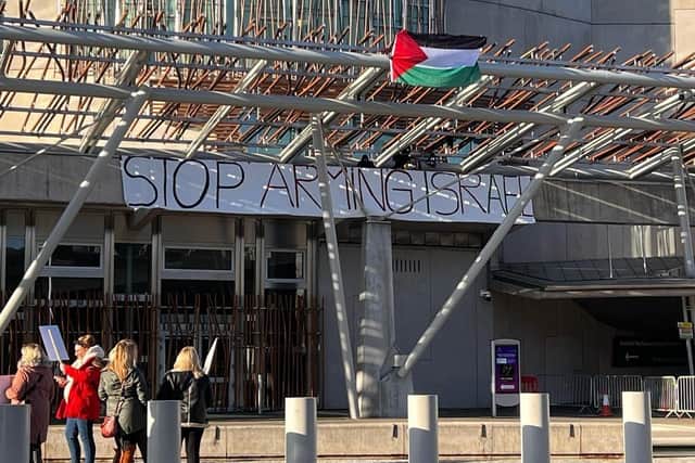 Four protesters have climbed onto the Scottish Parliament roof. Picture: Lisa Ferguson
