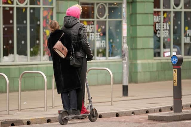 A couple ride an electric scooter in a cycle lane through Manchester city centre (Picture: Christopher Furlong/Getty Images)