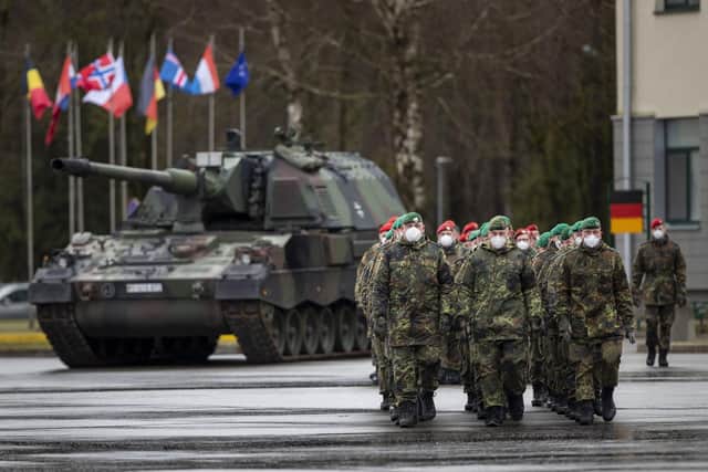 German Bundeswehr soldiers of the NATO enhanced forward presence battalion waits to greet German Defense Minister Christine Lambrecht upon his arrival at the Rukla military base on Tuesday, Feb. 22, 2022. Photo: AP Photo/Mindaugas Kulbis.
