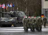 German Bundeswehr soldiers of the NATO enhanced forward presence battalion waits to greet German Defense Minister Christine Lambrecht upon his arrival at the Rukla military base on Tuesday, Feb. 22, 2022. Photo: AP Photo/Mindaugas Kulbis.