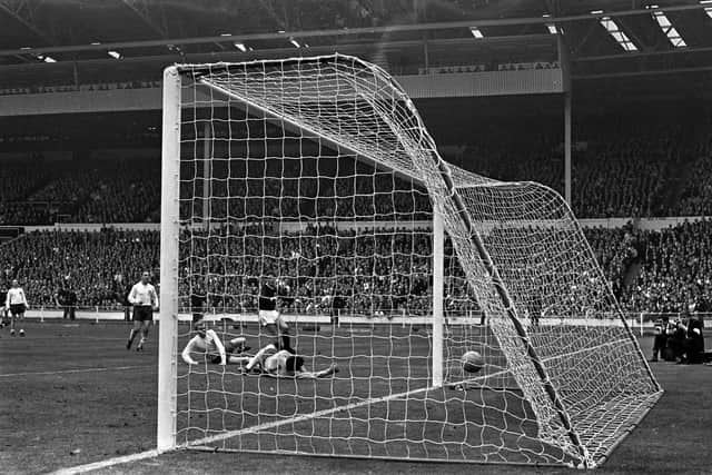 Bobby Moore and Gordon Banks are left sprawled on the turf as Jim McCalliog scores against world champions England in 1967. Picture: PA Wire