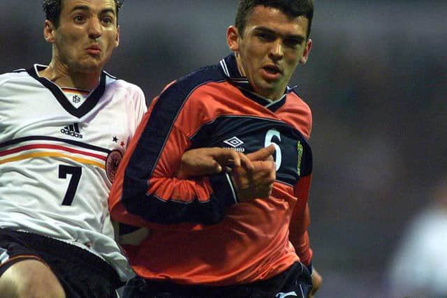 Davidson jousts with Germany's Oliver Neuville before laying on the winning goal for Don Hutchison in a 1999 friendly.