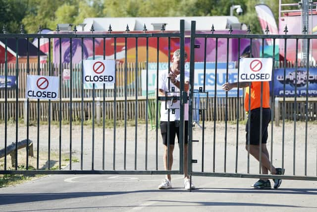 Closed signs on the gates of Liquid Leisure in Windsor, following the death of an 11-year-old girl. Emergency services were called at around 3.55pm on Saturday to reports of the child getting into difficulty at the water park near Datchet. Picture date: Sunday August 7, 2022.