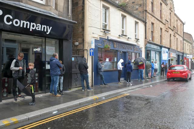 A socially distanced queue for Retson's Barber Shop in Manor Street, Falkirk (Picture: Michael Gillen)