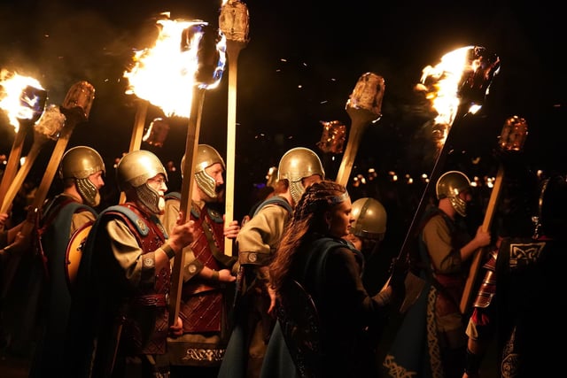 Squad members take part in the torch procession in Lerwick on the Shetland Isles during the Up Helly Aa fire festival. Picture: Andrew Milligan/PA Wire