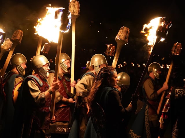 Squad members take part in the torch procession in Lerwick on the Shetland Isles during the Up Helly Aa fire festival. Picture: Andrew Milligan/PA Wire