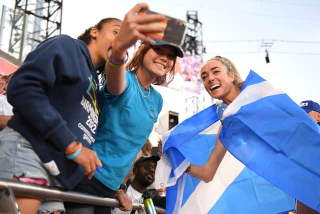 Eilish McColgan poses with some spectators after winning the silver medal in the Women's 5000m Final. (Photo by Tom Dulat/Getty Images)