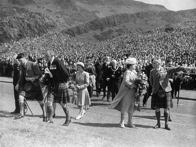 The Royal Party cross the road to the Saluting Base prior to the British Legion Parade at King's Park, Holyrood House, in 1946. King George VI is pictured with Queen Elizabeth and the then Princess Elizabeth in the centre.
