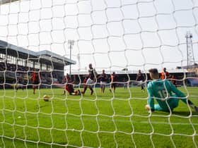Hearts' Liam Boyce scores the opening goal during a cinch Premiership match between Dundee United and Hearts at Tannadice, on August 28, 2021.