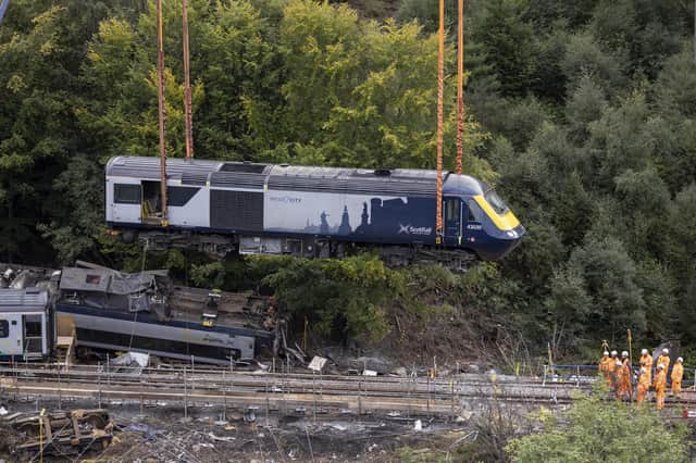 Part of the crashed train being lifted by crane from the site today. Picture: Derek Ironside/Newsline MediaDerek/PA Wire