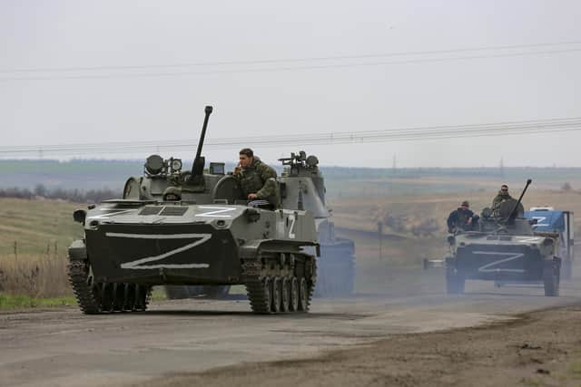 Russian military vehicles move on a highway in an area controlled by Russian-backed separatist forces near Mariupol, Ukraine