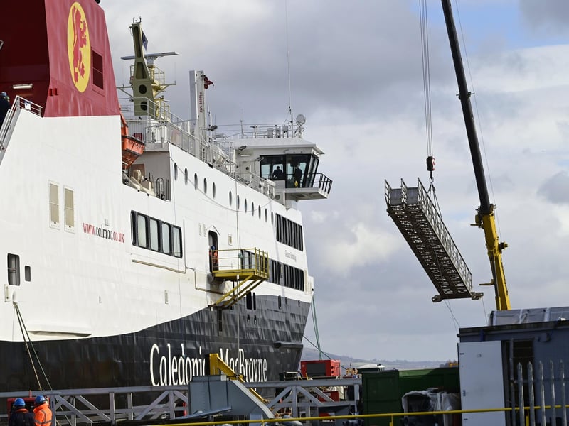 A small crane is deployed after the Glen Sannox has been boarded to prepare it for sailing on the Clyde. Picture: John Devlin