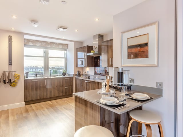 Interior: Stairs and a lift lead to the penthouse with sunroom, featuring bi-folding doors leading to a private balcony. The apartment’s open-plan kitchen, dining, and living room benefits from two bay windows.
Contact Strutt & Parker