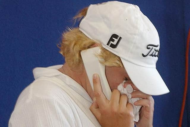 Mhairi Mckay wipes tears from her eyes as she calls her mother after winning the 2003 AAMI Australian Open in Sydney. Picture: Chris McGrath/Getty Images.