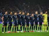 Scotland's players stand during the national anthem ahead of the FIFA World Cup Qatar 2022 Group F qualification football match between Scotland and Israel at Hampden Park in Glasgow on october 9, 2021. (Photo by ANDY BUCHANAN/AFP via Getty Images)