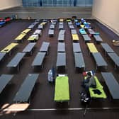 A Ukrainian war refugee sits on a camp bed in a sports hall in the small Bavarian village of Eichenau near Munich, southern Germany. Picture: Christof Stache/AFP via Getty Images