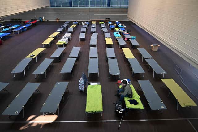 A Ukrainian war refugee sits on a camp bed in a sports hall in the small Bavarian village of Eichenau near Munich, southern Germany. Picture: Christof Stache/AFP via Getty Images