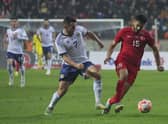 Turkey's Ozan Kabak, right, fights for the ball with Scotland's John McGinn. (AP Photo)