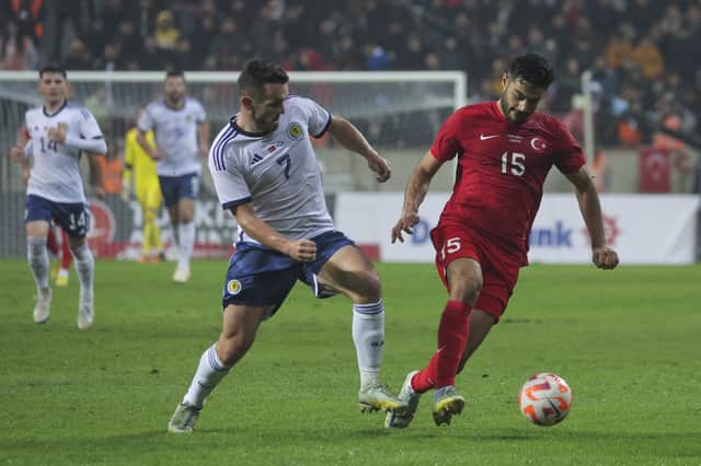 Turkey's Ozan Kabak, right, fights for the ball with Scotland's John McGinn. (AP Photo)