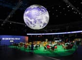 The Earth hangs over an empty Action Zone in the OVO Hydro building during the COP26 summit in Glasgow last year
