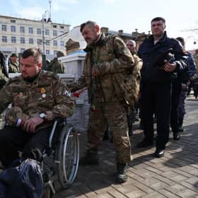 Attendees, including relatives of fallen participants in the Russian military action in Ukraine, take part in the opening ceremony of the obelisk in honour of the fallen heroes of the invasion of Ukraine, in Crimea, last week. Picture: AFP via Getty Images