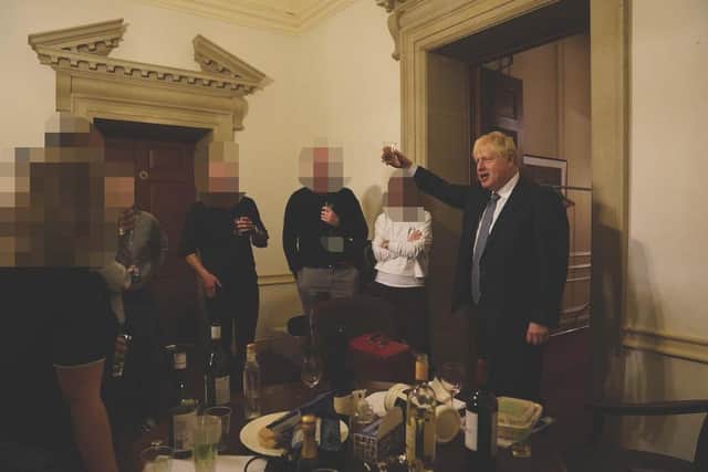 Boris Johnson raises a glass at what he still insists was a work event.
