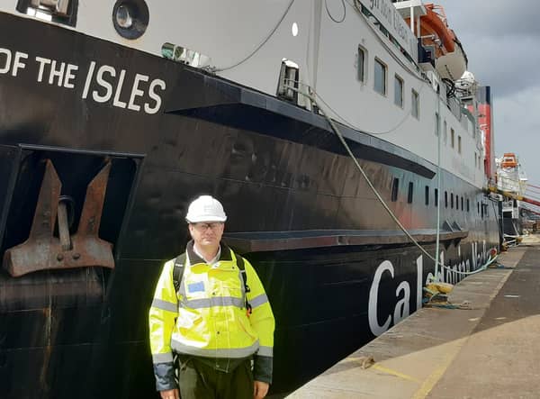 CalMac head of engineering Alex Cross beside Lord of the Isles during its repair in Greenock in May. Picture: The Scotsman