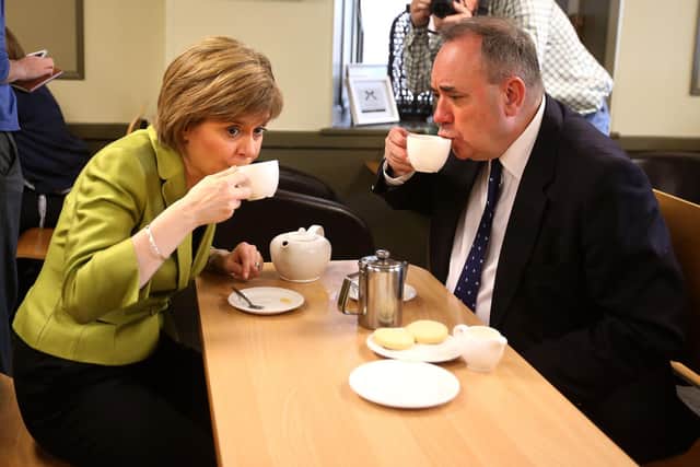 Nicola Sturgeon and Alex Salmond take a break from campaigning in Inverurie in the days when they were close political allies (Picture: Andrew Milligan/PA)