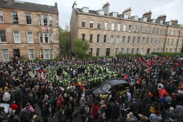 Two men are released from the back of an Immigration Enforcement van in Kenmure Street, Glasgow after it was surrounded by protesters.