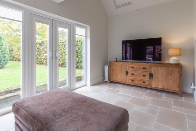 The garden room has the stone flagged floor and vaulted ceiling, French doors lead out to the rear.