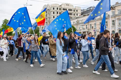 Young Moldovans waving EU and Moldovan flags take part in a march in Chisinau to celebrate Europe Day. Picture: Elena Covalenco/AFP