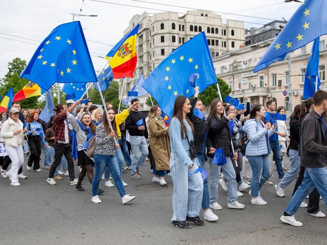 Young Moldovans waving EU and Moldovan flags take part in a march in Chisinau to celebrate Europe Day. Picture: Elena Covalenco/AFP